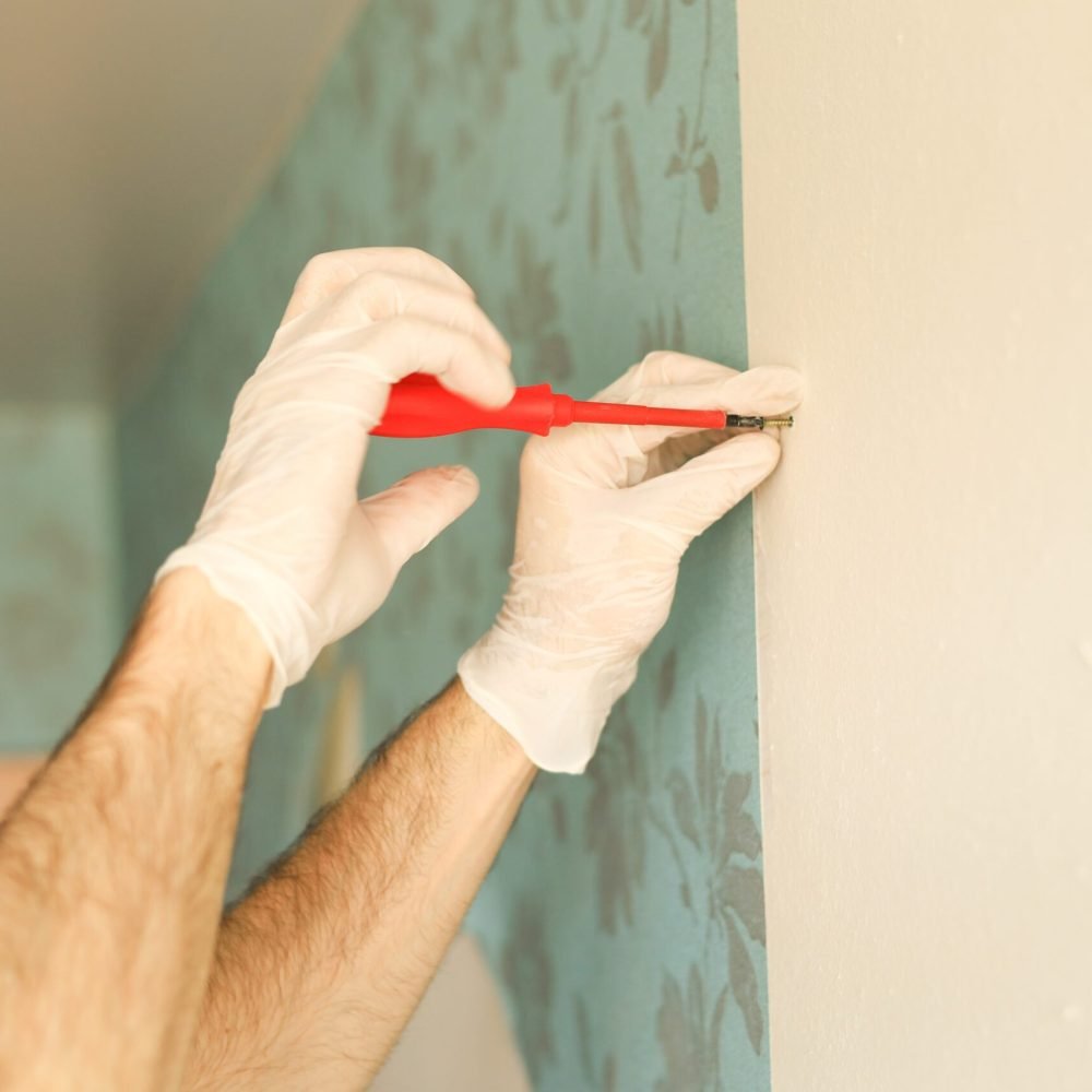 strong-male-hands-screw-a-screw-into-the-wall-with-2025-01-08-20-35-54-utc